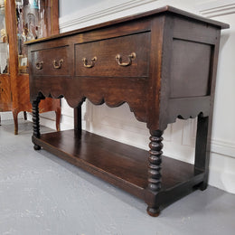 Rare size 19th Century English oak dresser base. It has two good size drawers and amazing patina. It has been sourced from France and in good original detailed condition.