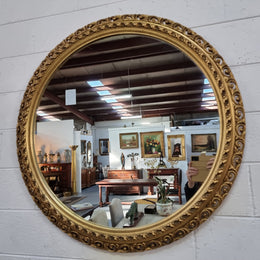 Decorative round gilt wall mirror.