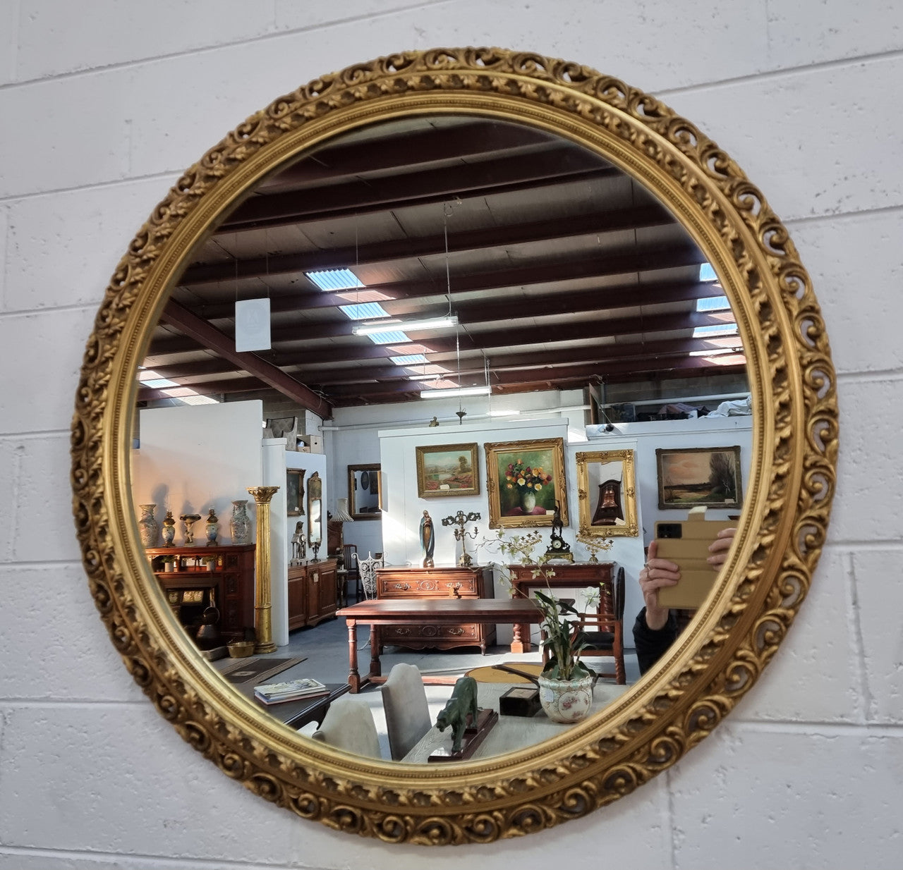 Decorative round gilt wall mirror.