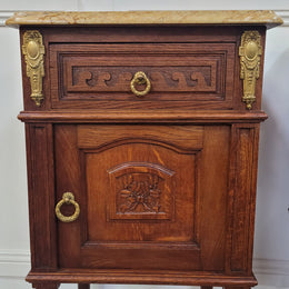 French Oak pair of Louis 16th style marble top bedsides with stunning bronze mounts. They have been sourced from France and are in good original detailed condition.