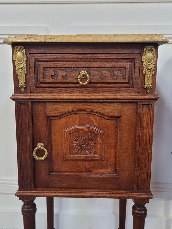 French Oak pair of Louis 16th style marble top bedsides with stunning bronze mounts. They have been sourced from France and are in good original detailed condition.