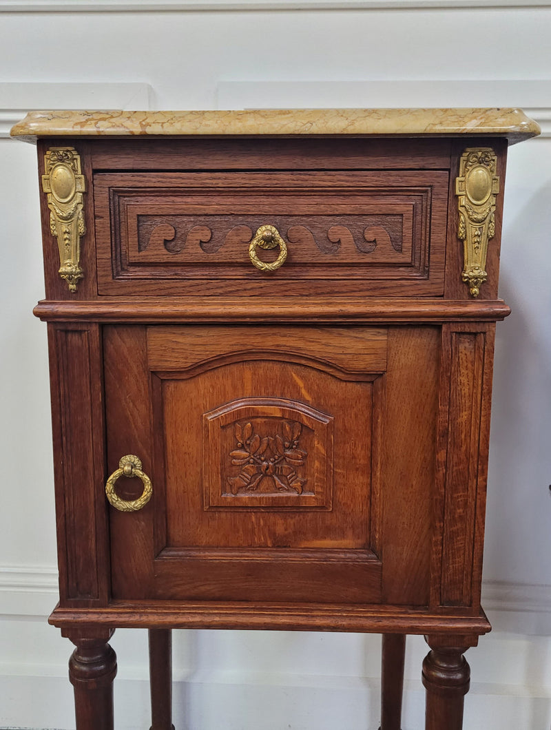 French Oak pair of Louis 16th style marble top bedsides with stunning bronze mounts. They have been sourced from France and are in good original detailed condition.