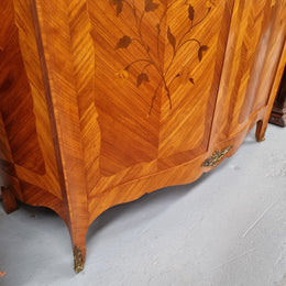 Charming French Louis XV Style Marquetry Inlaid Two Door Armoire. Features three adjustable shelves and ormolu trim. It has been sourced from France and is in good original condition.
