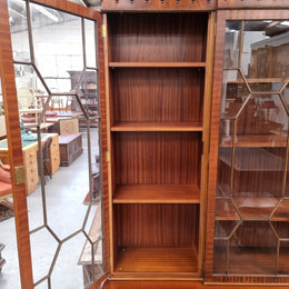 Georgian style Breakfront Flame Mahogany four door bookcase. A very impressive piece with plenty of storage and is of pleasing narrow proportions. It has been sourced locally and is in good original detailed condition.