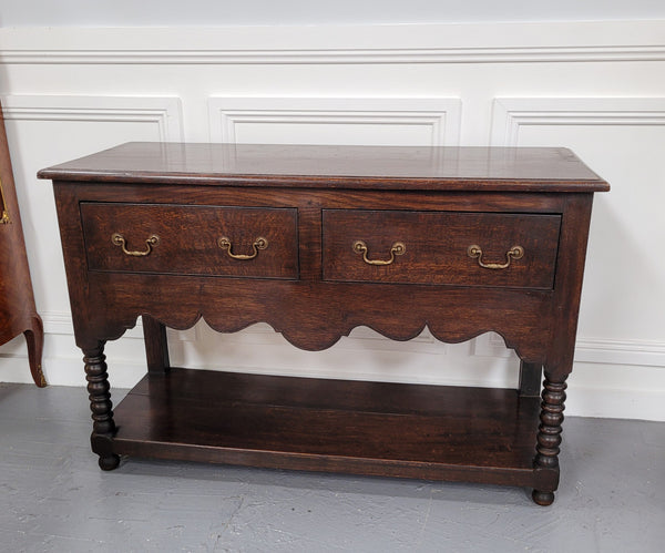 Rare size 19th Century English oak dresser base. It has two good size drawers and amazing patina. It has been sourced from France and in good original detailed condition.