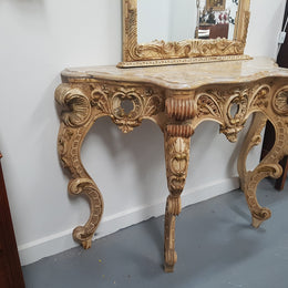 Beautifully carved Italian Rococo style painted console/hall table and mirror. An amazing coloured marble top showing sections of gold veins and is in good condition. Mantle mirror is retaining it's original mirror and showing ages spots.