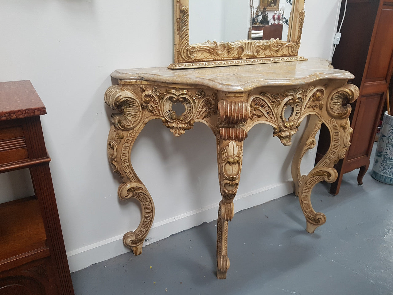 Beautifully carved Italian Rococo style painted console/hall table and mirror. An amazing coloured marble top showing sections of gold veins and is in good condition. Mantle mirror is retaining it's original mirror and showing ages spots.
