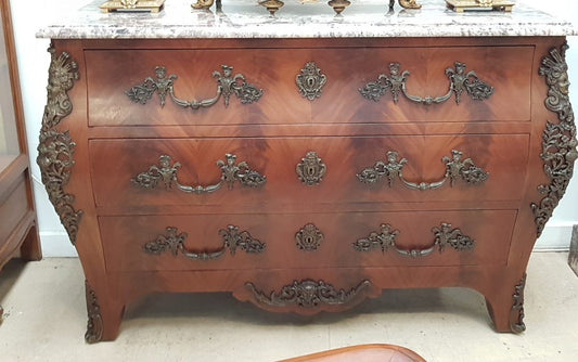 A Grand French Louis XV Style Flame Mahogany Commode
