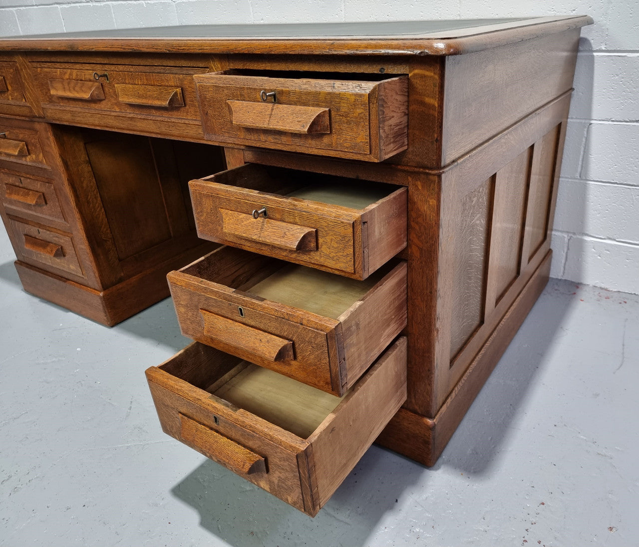 Amazing American Oak full partners leather top desk. Plenty of storage space with nine drawers on one side and two cupboards of the oppsite side. It is in good restored condition and has a new leather and gold tooled inset top.