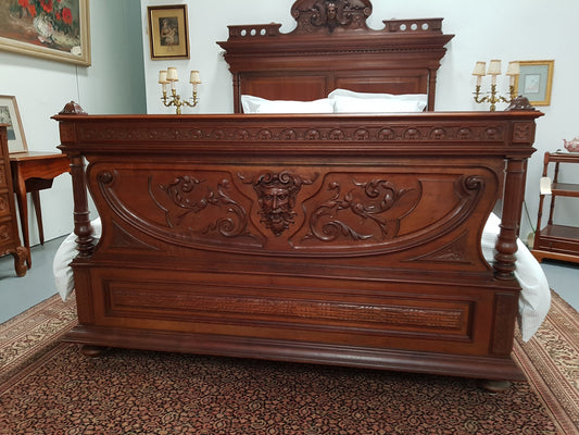 Grand French Henry II style Mahogany queen size bed. Very detailed carvings and comes with custom made bed slats, simply just put your mattress on top. In very good condition.
