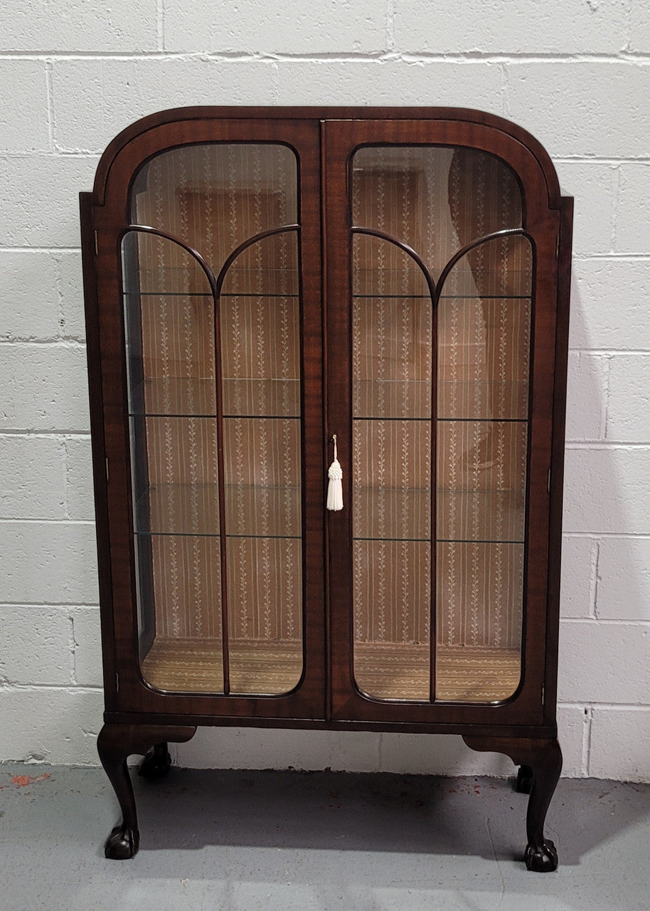 Chippendale style Walnut display cabinet of pleasing narrow portrions. It is in good original condition and comes with three shelves.