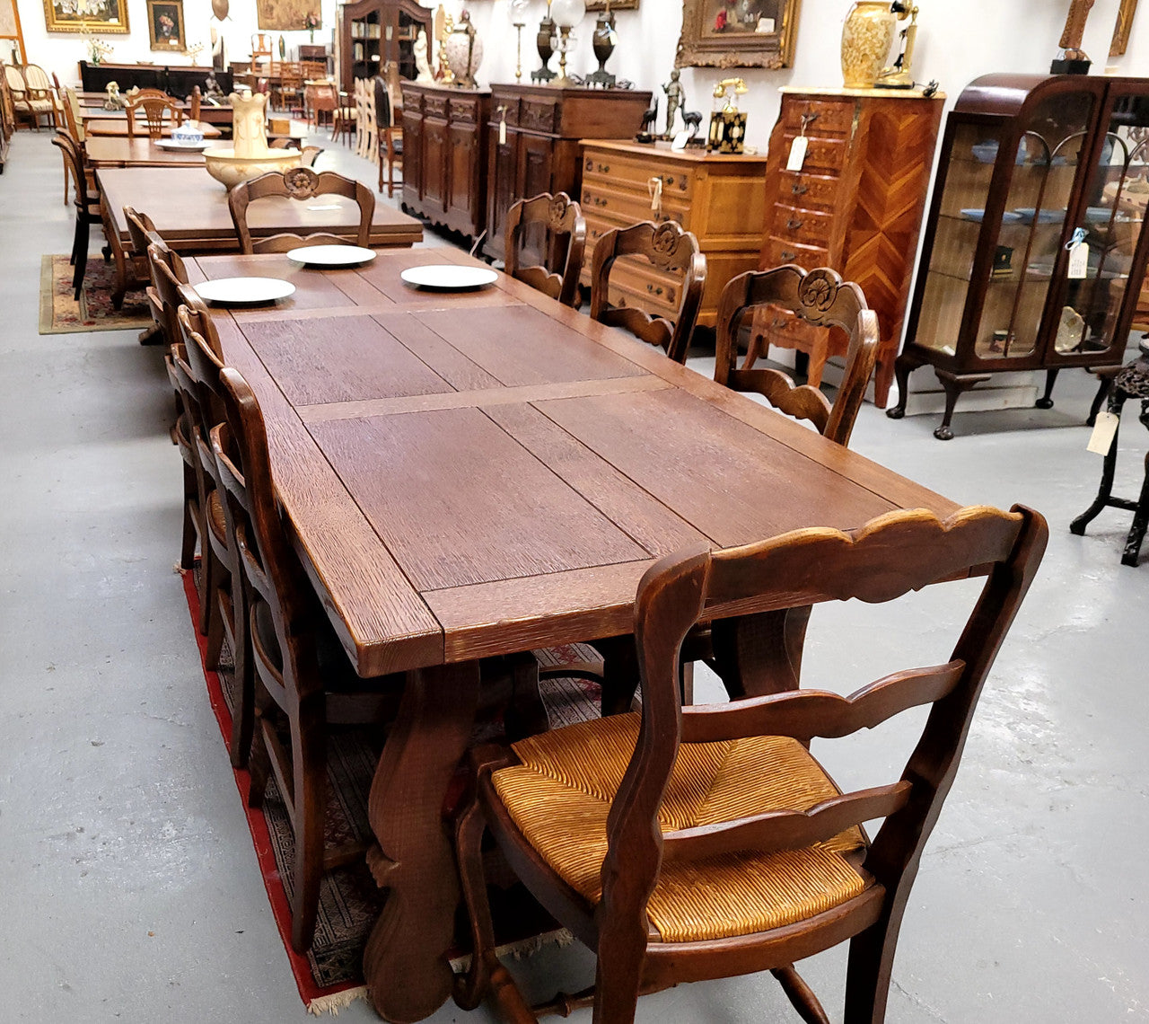 Purchased from France we have this amazing French Oak Spanish style farmhouse table featuring striking iron work underneath. It has been finished with an oil & wax finish making it more water resistant, stain resistant and durable then a natural wax finish. It can sit 6-8 people comfortable and is good restored condition.