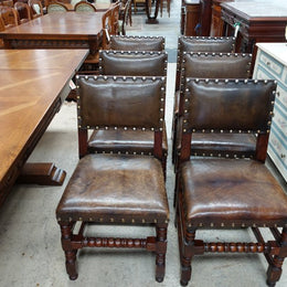 Here we have a fabulous set of six French oak rustic leather dining chairs with two carvers. Chairs are upholstered in brown leather and are very comfortable and solid. Is in very good original condition.