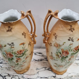 Decorative Pair of Art Nouveau Vases decorated with hand finished roses in muted tones. Gilt highlights. Impressed numbers to base. In good original condition, please view photos as they help form part of the description.