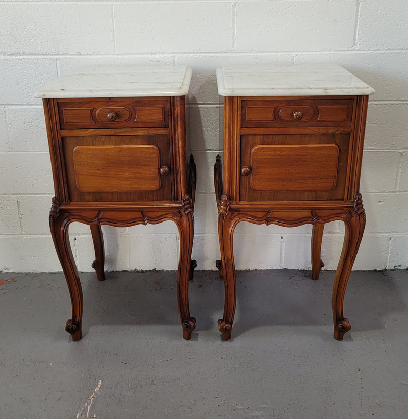 Pair of stunning Louis XV style French Walnut white marble top bedside cabinets. They have one drawer and a cupboard that is marble lined. The marble has been polished and they are in good original detailed condition.