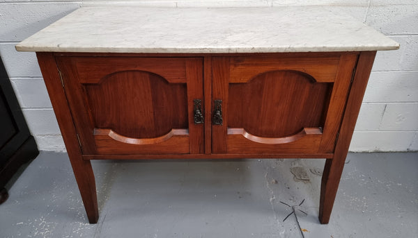 Blackwood two door white marble top cabinet. This would be ideal to be used as an entertainment unit, a TV stand or TV cabinet. In good original condition.