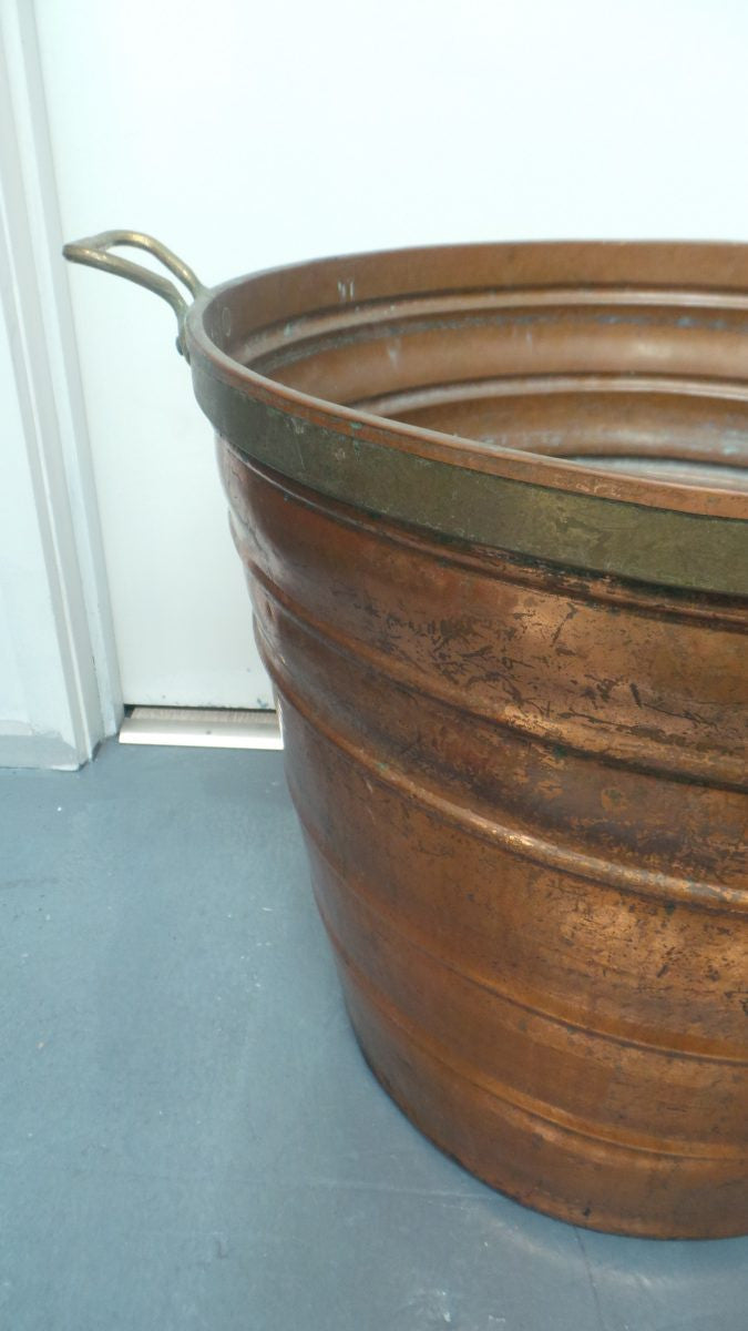 A fabulous French rustic antique copper and brass two handled bucket. Has loads of character and would make a great bucket for firewood. It is in very good original condition