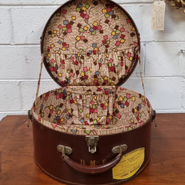 Charming solid leather hatbox with patterned fabric interior and two interior pockets. Interior stamp is for The Mutual Store Melbourne. Bears paper stamps for P&O Cruise Passenger” & “Peninsular  the top and D.M.F. in gold near the handle. Circa: Early 1900’s. 43 cm across and H:21 cm the lid.