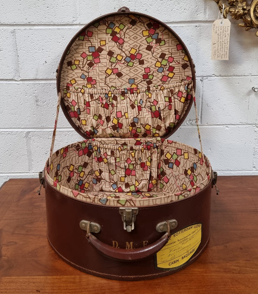 Charming solid leather hatbox with patterned fabric interior and two interior pockets. Interior stamp is for The Mutual Store Melbourne. Bears paper stamps for P&O Cruise Passenger” & “Peninsular  the top and D.M.F. in gold near the handle. Circa: Early 1900’s. 43 cm across and H:21 cm the lid.