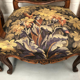Pair of 19th Century French walnut tapestry covered arm chairs. They are in good original condition. Circa 1890.