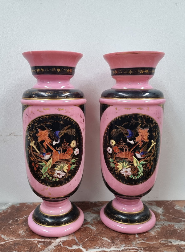 Late Victorian pink and hand painted, enameled pair of vases with some ware to enameling. It is in good original condition.