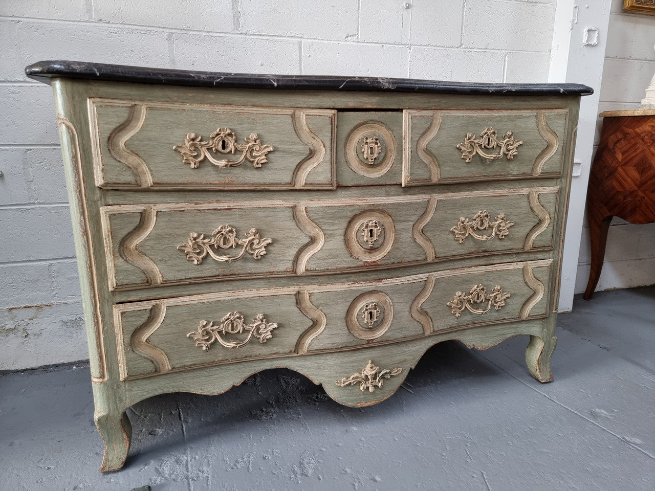 Early 19th Century Louis XIV style faux marble top and painted base commode. It is of large proportions and has four drawers. In good original detailed condition.