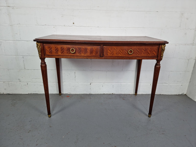 Lovely parquetry inlaid French late 19th Century Louis XV style desk. It has two drawers and decorative mounts and handles. In good original detailed condition.