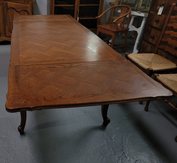 French Oak Louis XV style parquetry top extension table. It can sit six people when not extended and eight when fully extended. It has been sourced from France and is in original detailed condition.