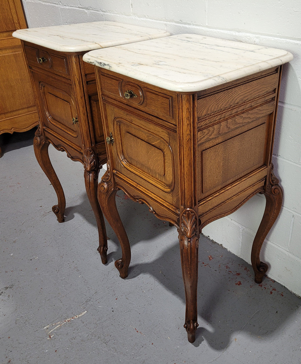 Pair of Louis XV style bedside cabinets with beautiful marble tops and one drawer and single cupboard for all your storage needs. In good original detailed condition.