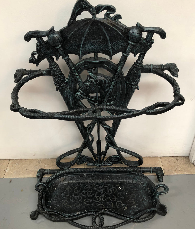 A black cast iron umbrella stand displaying a horse in the middle with four dogs on the side. In good original condition.