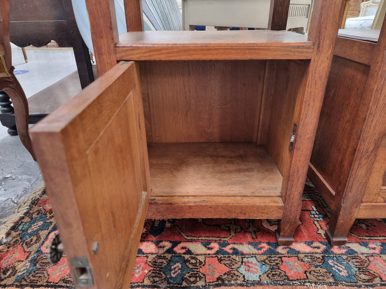 Charming pair of French Oak Arts and Crafts bedsides with shelf, cupboard with carving and marble top.  They have been sourced from France and are in good original detailed condition.