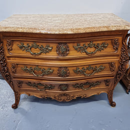 Impressive Louis XV style three drawer walnut commode. Ormolu handles and bevelled marble top complimenting detailed carving. In very good original detailed condition.