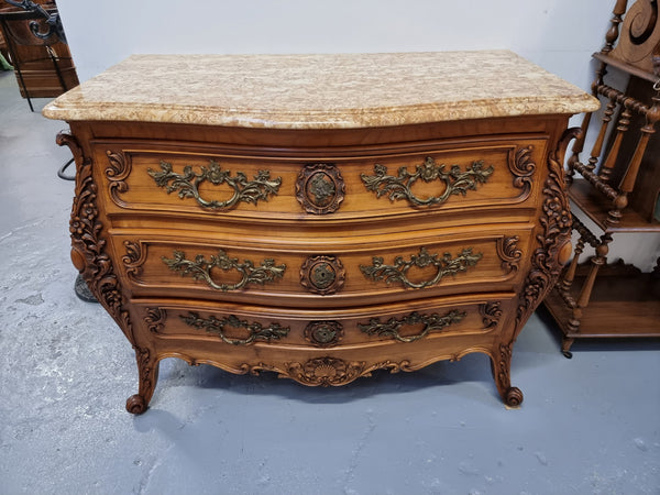 Impressive Louis XV style three drawer walnut commode. Ormolu handles and bevelled marble top complimenting detailed carving. In very good original detailed condition.