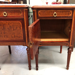 A lovely French inlaid pair of flame mahogany bedside cabinets with ormolu and in good condition.