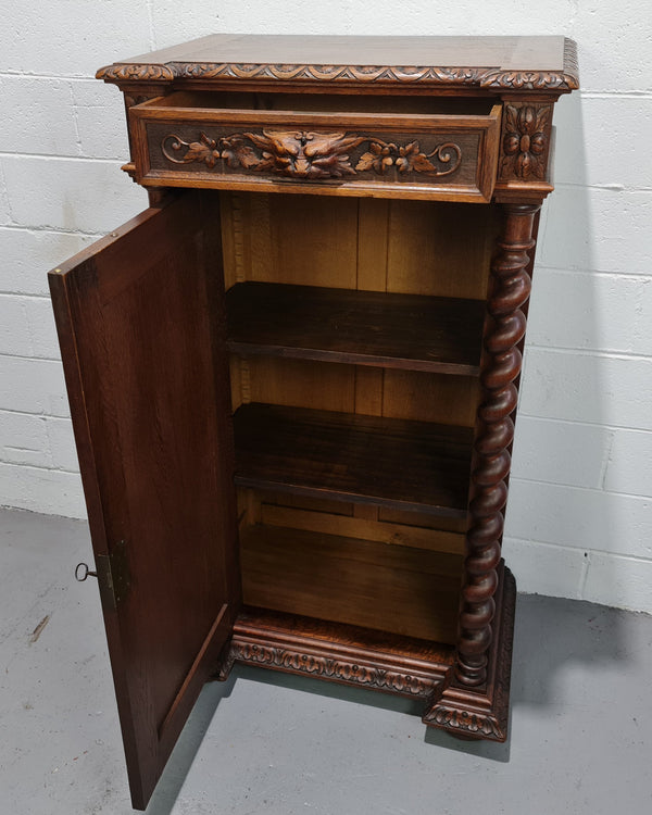 French Henry 2nd Oak Side Cabinet of pleasing narrow proportions.  Carving on the cup board and drawer fronts with barley twist columns.