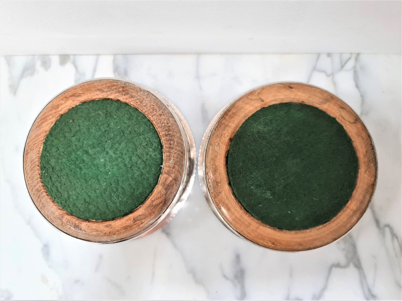 Gorgeous pair of vintage silver plate wine coasters with stunning turned wooden base. Not marked. In great original condition.