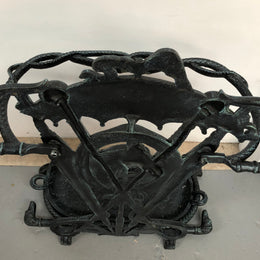 A black cast iron umbrella stand displaying a horse in the middle with four dogs on the side. In good original condition.
