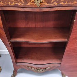 Stunning French Transitional style Mahogany marquetry inlay salon cabinet in the bombe shape. It has one draw, one shelf, marble top & ormolu decoration. Sourced from France and in good original detailed condition.