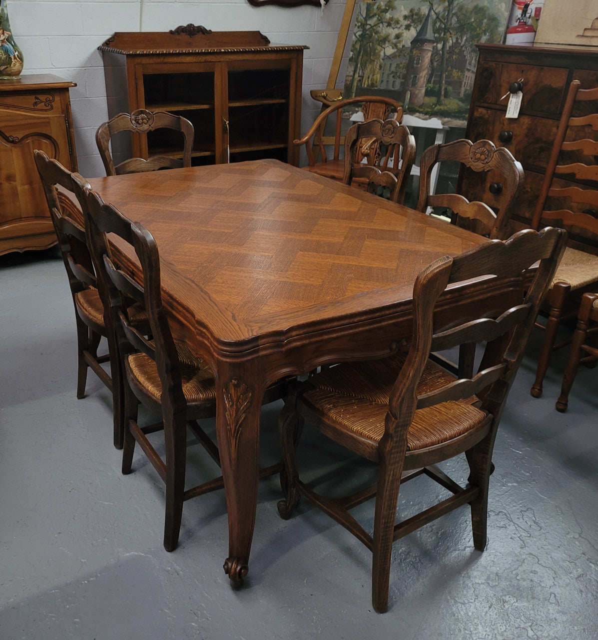 French Oak Louis XV style parquetry top extension table. It can sit six people when not extended and eight when fully extended. It has been sourced from France and is in original detailed condition.