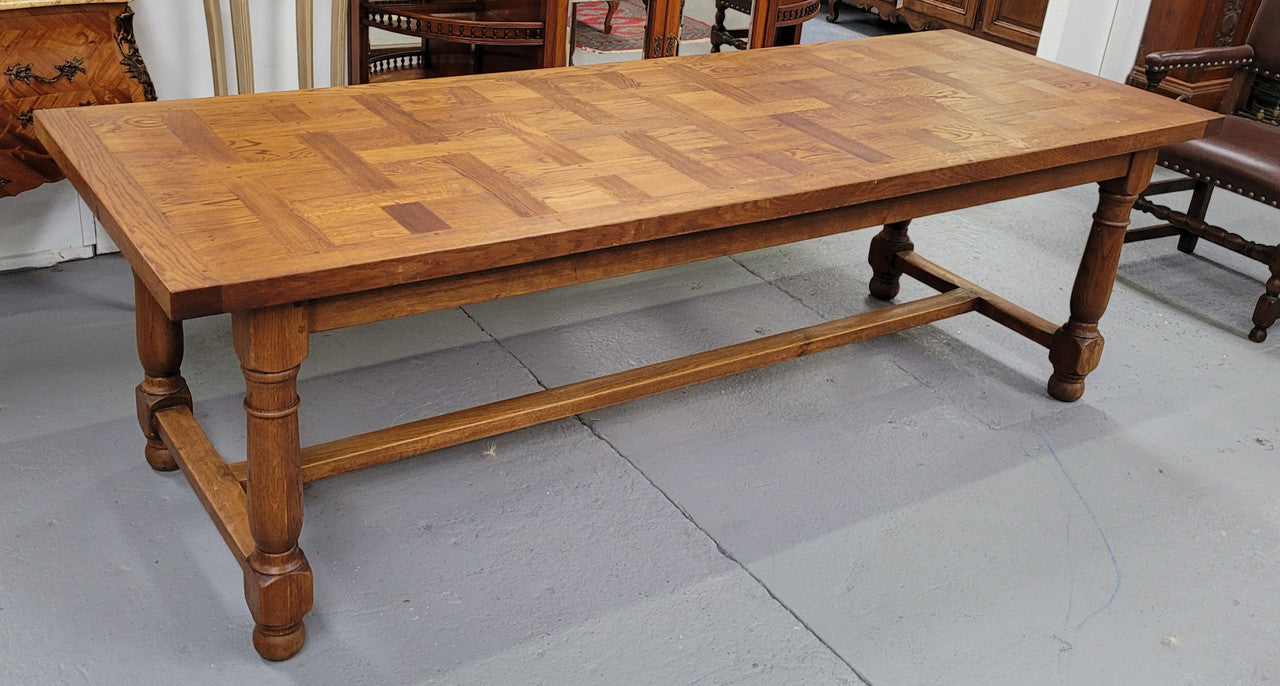French Oak Refectory dining table with a parquetry top. Sourced from France this table comfortably sits eight to ten. It is in good original detailed condition.