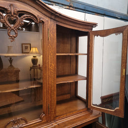 Impressive French Oak Louis 14th Style Display and Sideboard. It has 4 drawers, 2 bottom cupboards with 6 total shelves and 3 display doors with 3 shelves.  In good, detailed condition.