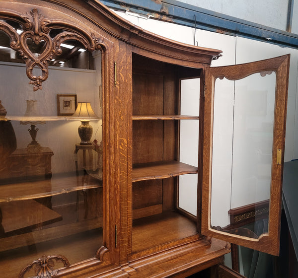 Impressive French Oak Louis 14th Style Display and Sideboard. It has 4 drawers, 2 bottom cupboards with 6 total shelves and 3 display doors with 3 shelves.  In good, detailed condition.