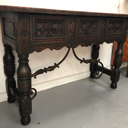 Spanish late 19th century carved oak three drawers console/side table. Superb wrought iron undercarriage. In good condition. Circa 1900's.