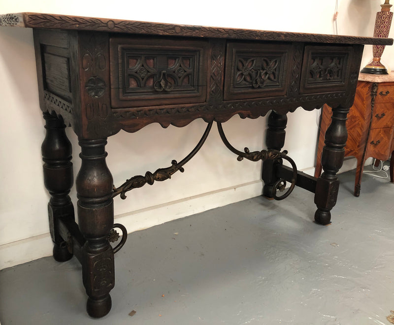 Spanish late 19th century carved oak three drawers console/side table. Superb wrought iron undercarriage. In good condition. Circa 1900's.