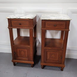 Pair of Antique French Oak Louis XVI style marble top bedside cabinets. They have decorative inlay and have been sourced from France. They are in good original detailed condition.