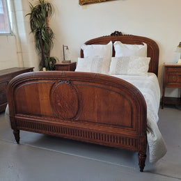 Elegant Louis XVI style French Oak queen size bed with a pair of matching inset marble top bedsides. The queen size beed comes with custom made bed slates and all you need to do is place your mattress on top. Bedsides and bed are in good original detailed condition.