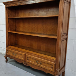 Lovely French Oak Louis XV style open shelf bookcase with two drawers for storage and three shelves in good original detailed condition.