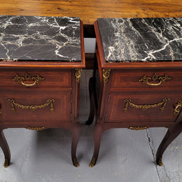 Appealing Louis XV style high quality bedside cabinets with black Portoro marble top and bronze mounts. They have been sourced from France and are in good original condition.