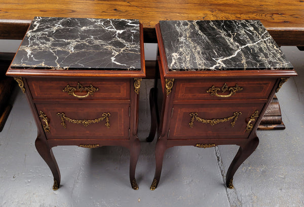 Appealing Louis XV style high quality bedside cabinets with black Portoro marble top and bronze mounts. They have been sourced from France and are in good original condition.