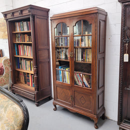 Beautiful four door Walnut bookcase with glass doors. The top section has two fully adjustable shelves and it is of pleasing narrow proportions. It is in good original detailed condition.